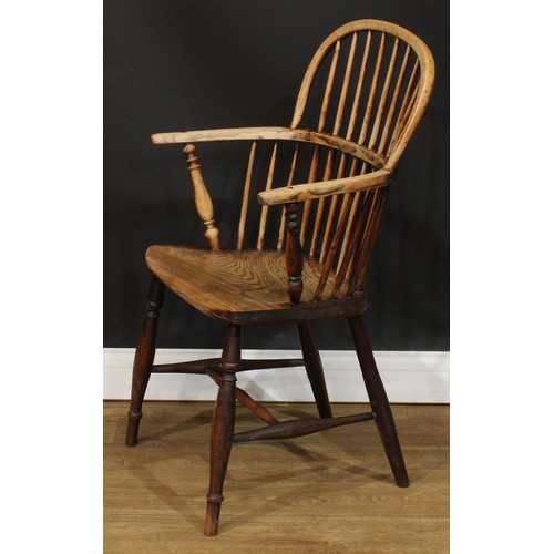 1404 - A 19th century beech and elm stick back Windsor elbow chair, hoop back, one-piece mid-rail, turned a... 