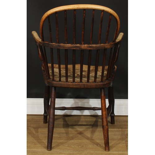 1404 - A 19th century beech and elm stick back Windsor elbow chair, hoop back, one-piece mid-rail, turned a... 