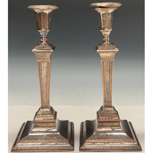 40 - A pair of George III Old Sheffield Plate square table candlesticks, campana sconces, fluted tapered ... 
