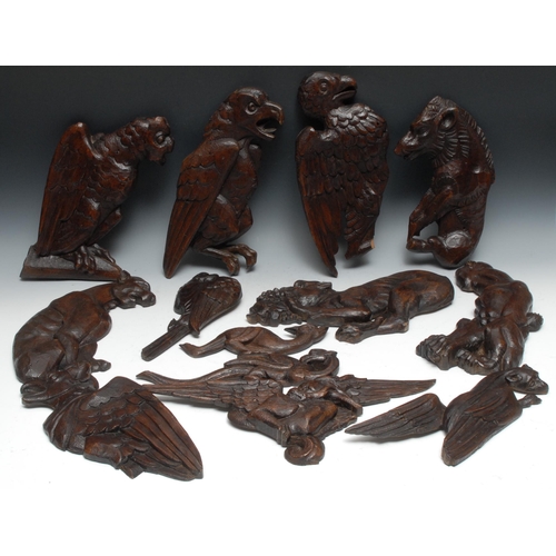 1388 - A 19th century carved oak wall plaque, as a mystical lion, 30cm high;  others, eagles, stylised owl ... 