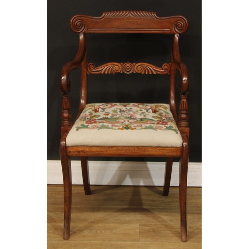 1615 - A George IV mahogany open armchair, curved parcel-gadrooned cresting rail carved with scrolls, shape... 