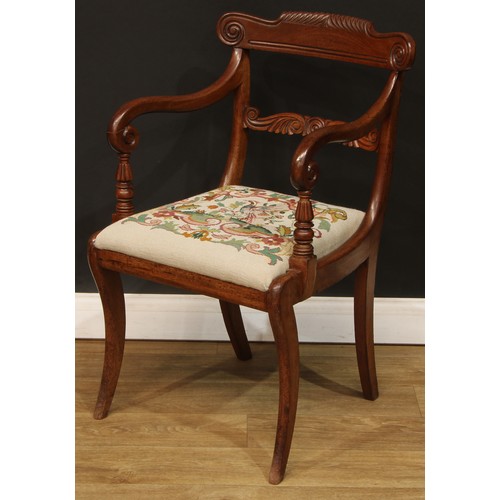 1615 - A George IV mahogany open armchair, curved parcel-gadrooned cresting rail carved with scrolls, shape... 