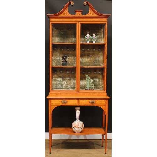 1833 - A Sheraton Revival satinwood display cabinet, by Maple & Co, stamped, swan neck pediment inlaid with... 