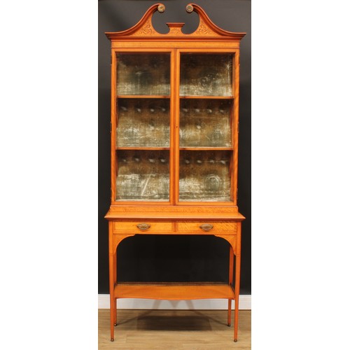 1833 - A Sheraton Revival satinwood display cabinet, by Maple & Co, stamped, swan neck pediment inlaid with... 