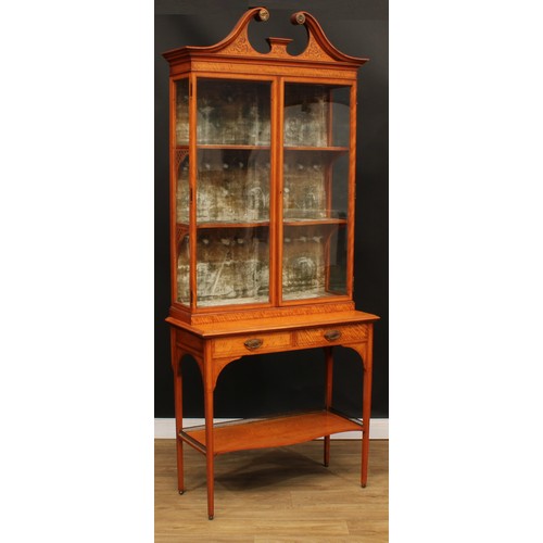 1833 - A Sheraton Revival satinwood display cabinet, by Maple & Co, stamped, swan neck pediment inlaid with... 