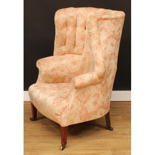 1612 - A George III Revival wingback armchair, stuffed-over upholstery, tapered square forelegs, brass cast... 