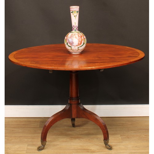 1768 - A Regency mahogany tripod centre table, crossbanded oval tilting top, cannon barrel column, stop-flu... 