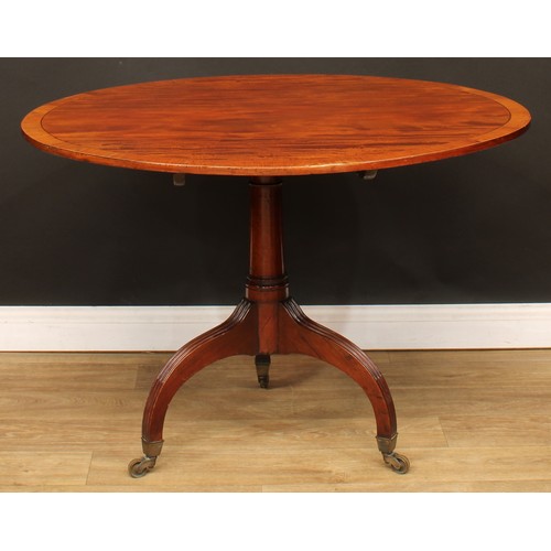 1768 - A Regency mahogany tripod centre table, crossbanded oval tilting top, cannon barrel column, stop-flu... 