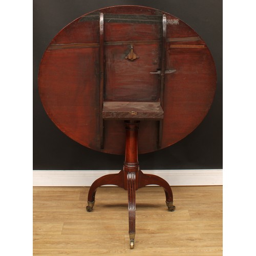 1768 - A Regency mahogany tripod centre table, crossbanded oval tilting top, cannon barrel column, stop-flu... 