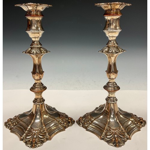 67 - A pair of George III Old Sheffield Plate table candlesticks, reel shaped sconces with detachable noz... 