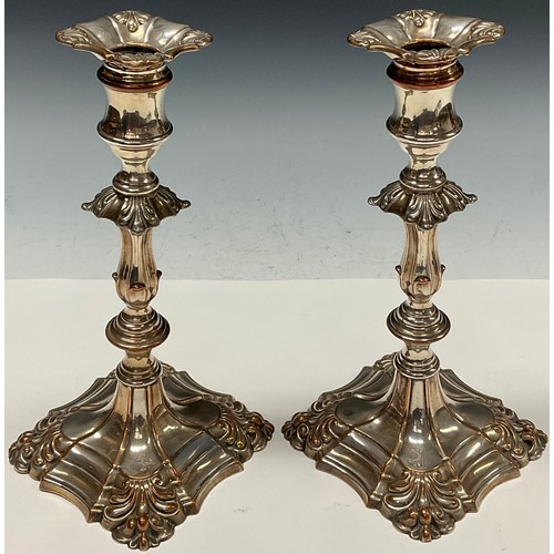 67 - A pair of George III Old Sheffield Plate table candlesticks, reel shaped sconces with detachable noz... 