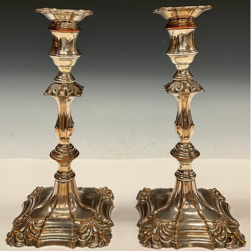 67 - A pair of George III Old Sheffield Plate table candlesticks, reel shaped sconces with detachable noz... 