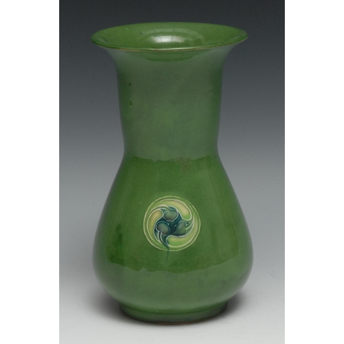 538 - A Moorcroft Flaminian pattern vase,  glazed in green, with three floral roundels, 18cm high,  signed... 