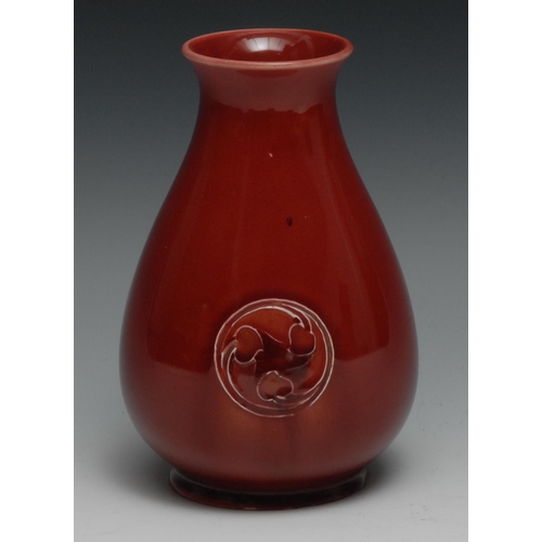 539 - A Moorcroft Flaminian pattern vase,  glazed in red, with three floral roundels, 16cm high,  signed W... 