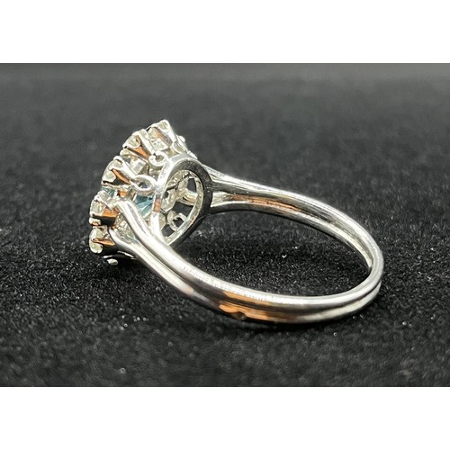 451 - A fine French platinum cluster ring, set with 10 old cut diamonds and centred with a natural blue zi... 