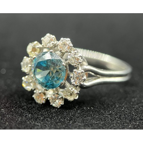 451 - A fine French platinum cluster ring, set with 10 old cut diamonds and centred with a natural blue zi... 