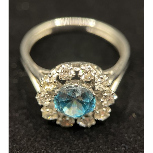 451 - A fine French platinum cluster ring, set with 10 old cut diamonds and centred with a natural blue zi... 