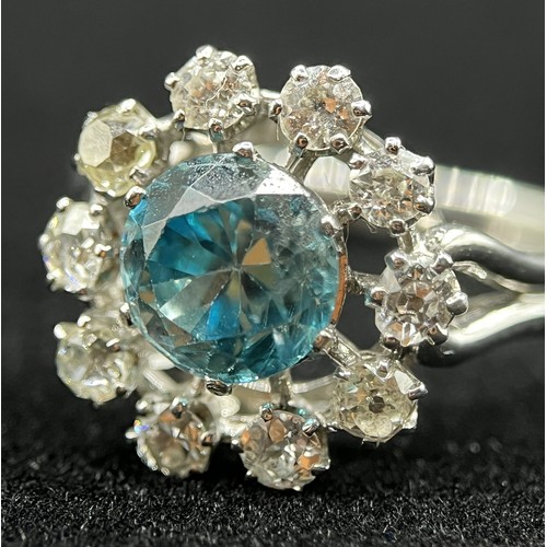 451 - A fine French platinum cluster ring, set with 10 old cut diamonds and centred with a natural blue zi... 