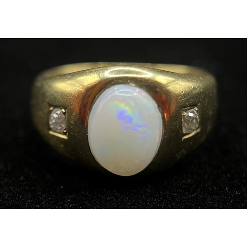 423 - A Victorian 18ct gold three stone opal and diamond ring, the central oval cabochon stone flanked by ... 