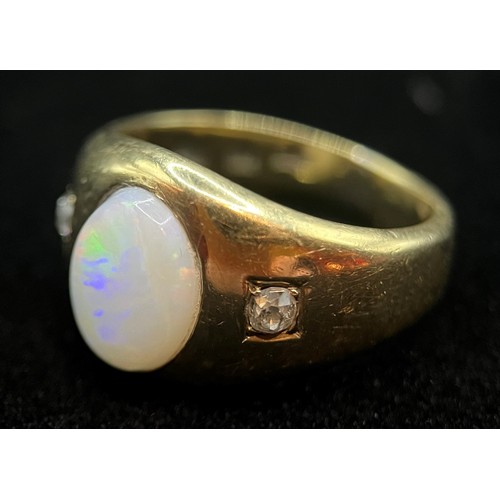 423 - A Victorian 18ct gold three stone opal and diamond ring, the central oval cabochon stone flanked by ... 