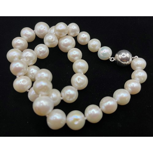 449 - A single strand pearl necklace of 35 large slightly graduated pearls, from 11mm to 15mm in diameter,... 