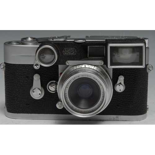 1755 - A Leica M3 camera, with wide angle and long lenses, serial no.1014323, brown leather case; an associ... 