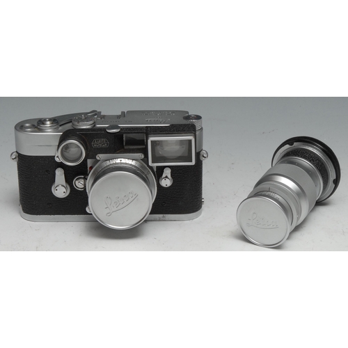 1755 - A Leica M3 camera, with wide angle and long lenses, serial no.1014323, brown leather case; an associ... 