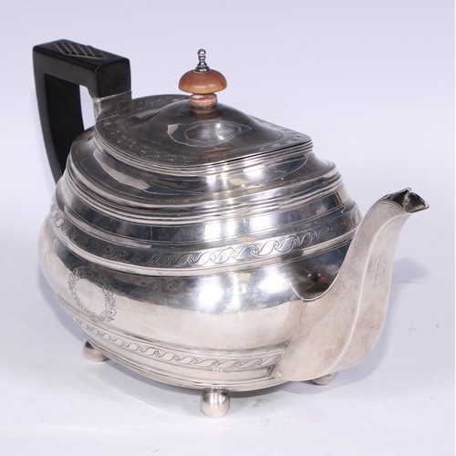 133 - A George III silver boat shaped teapot, bright-cut engraved with bands of Vitruvian scrolls, outline... 