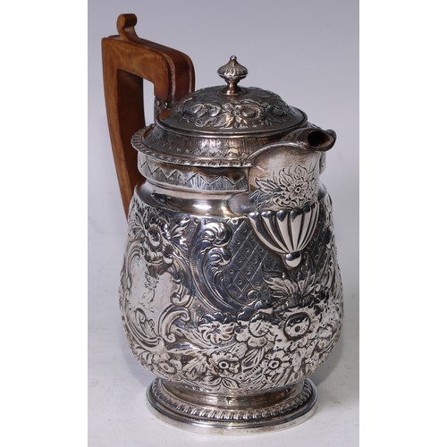 152 - A George III silver water jug, later chased with flowers, scrolling foliage and panels of trellis, 1... 