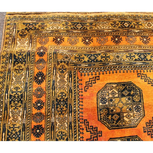 1364 - An Afghan Turkmen Ersari carpet, the central field with twelve guls interspersed with hooked medalli... 