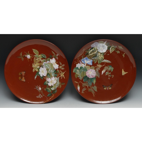 489 - A pair of Minton's Aesthetic Movement chargers, painted in polychrome with flowers and butterflies o... 