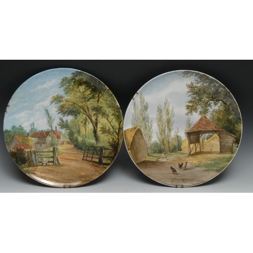 490 - A pair of T C Brown Westhead Moore & Co Aesthetic Movement chargers, painted by Julia Gauci, signed,... 