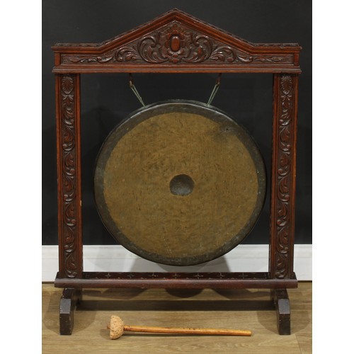 1657 - A late 19th century oak dinner gong, pointed arch pediment carved in relief with a floral cartouche ... 