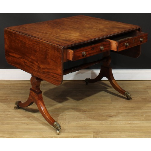 1767 - A Regency mahogany sofa table, rounded rectangular top with reeded edge and fall leaves above a pair... 