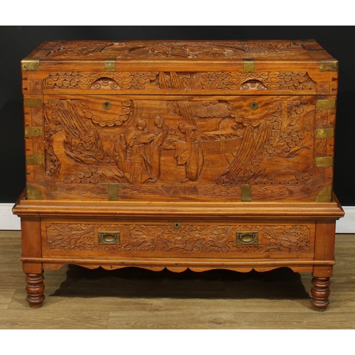 1836 - A Southeast Asian brass-mounted camphor chest on stand, hinged top enclosing a tray, carved througho... 