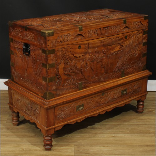 1836 - A Southeast Asian brass-mounted camphor chest on stand, hinged top enclosing a tray, carved througho... 