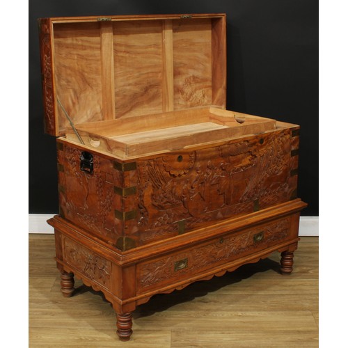 1836 - A Southeast Asian brass-mounted camphor chest on stand, hinged top enclosing a tray, carved througho... 