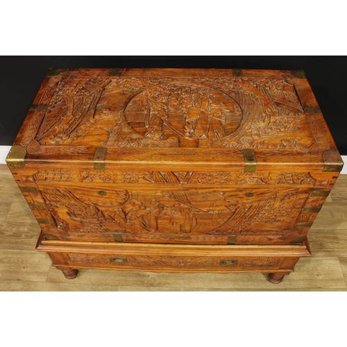 1836 - A Southeast Asian brass-mounted camphor chest on stand, hinged top enclosing a tray, carved througho... 