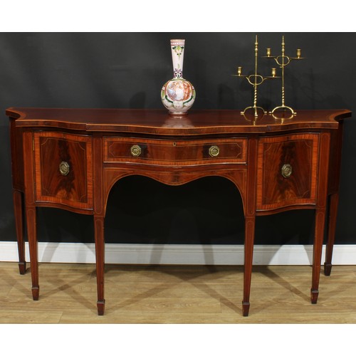 1831 - A Sheraton Revival satinwood crossbanded mahogany serpentine serving table or sideboard, slightly ov... 