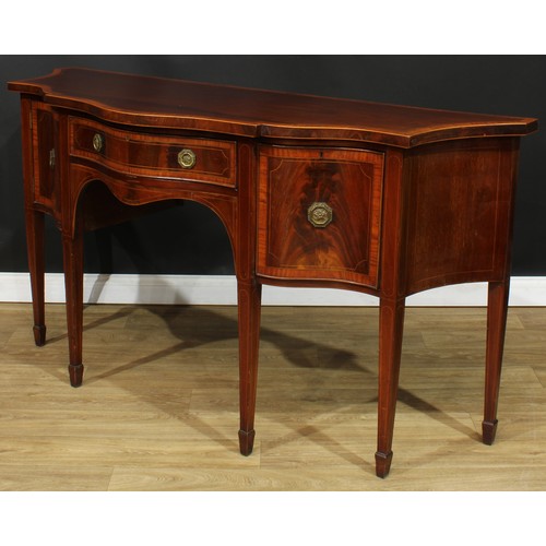 1831 - A Sheraton Revival satinwood crossbanded mahogany serpentine serving table or sideboard, slightly ov... 