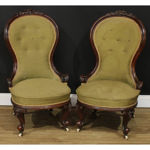A pair of Victorian mahogany spoon back drawing room chairs, each with