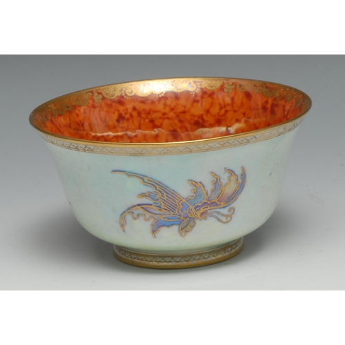 558 - A Wedgwood Fairyland lustre flared circular bowl, the interior with butterfly on a mottled orange gr... 