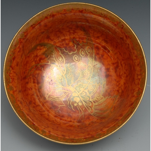 558 - A Wedgwood Fairyland lustre flared circular bowl, the interior with butterfly on a mottled orange gr... 