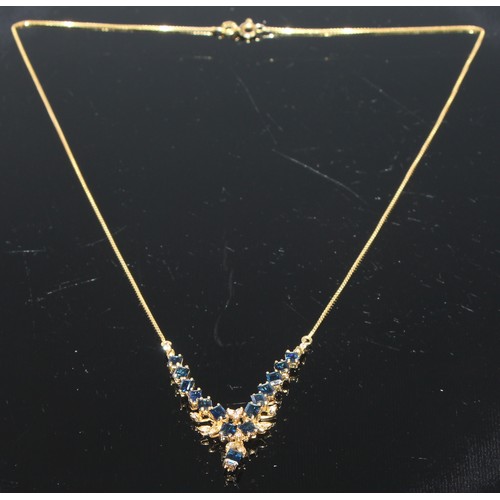 410 - A 14ct gold and sapphire necklace, accented with diamonds, marked 585, boxed with soft cloth pouch