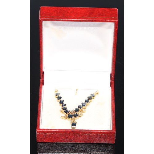 410 - A 14ct gold and sapphire necklace, accented with diamonds, marked 585, boxed with soft cloth pouch