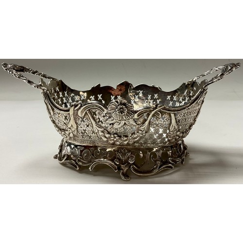 110 - A Dutch silver shaped oval basket, pierced border applied with flowers and swags, 20cm over handles,... 