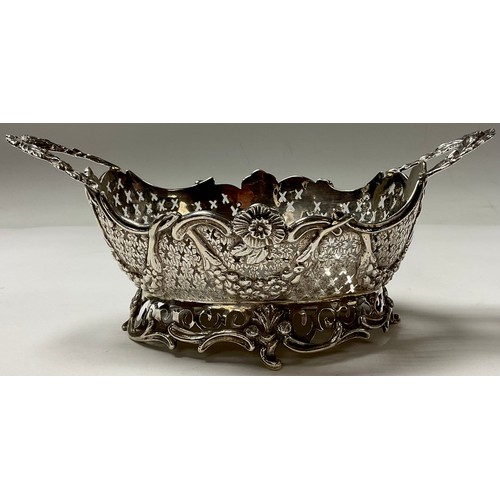 110 - A Dutch silver shaped oval basket, pierced border applied with flowers and swags, 20cm over handles,... 