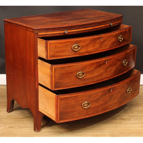 1777 - A Regency satinwood banded mahogany bowfront chest, slightly oversailing top above a slide and three... 