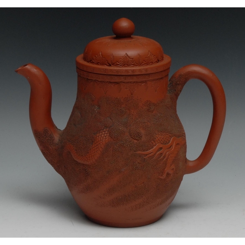 992 - A Chinese Yixing ovoid wine pot, in relief with ferocious dragons, 22cm high, impressed seal mark