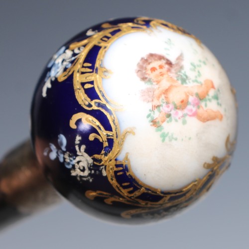 1337 - A Continental porcelain mounted walking stick, globular pommel decorated with a putto scattering flo... 